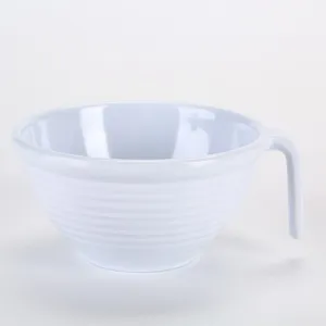 Detail view of the white melamine ribbed mixing bowl with a convenient side handle.