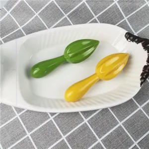 Manual lemon squeezer plastic reamer and ice muddler tool set for kitchen and bar detail.