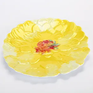 Yellow flower-shaped melamine dinner plate, detailed close-up showing vibrant floral center.