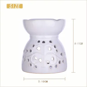 White ceramic candle oil burner aroma diffuser with hollow out floral design size 11x10cm.