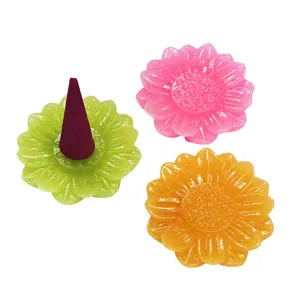 Set of colorful resin flower-shaped incense cone holders in green, pink, and yellow colors