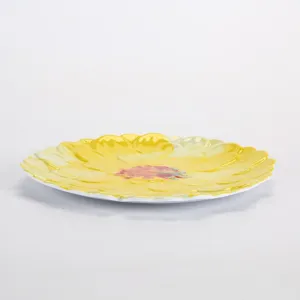 Detailed close-up view of yellow floral melamine plate, elegant petal shaped tableware.