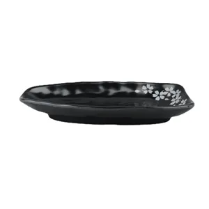 Black melamine dinner plate with cherry blossom design, wavy edge serving dish for kitchen.