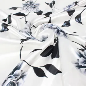 Detailed view of black and white floral pattern on satin finish silk-like scarf