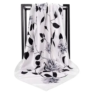 Detailed view of white silk-like 90cm square scarf with black floral print drape