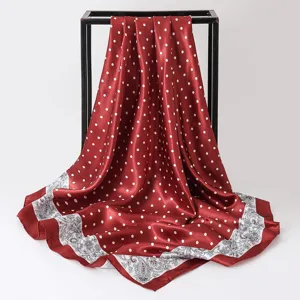 Detail showing the red polka dot satin square scarf with elegant paisley border
