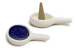 Detailed view of white ceramic handle tray holding incense cone and tealight candle for home.