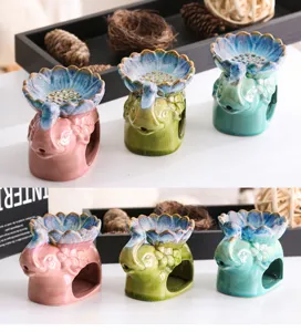 Gedetailleerde weergave van keramische olifant-wierookbranders met lotusbloemen