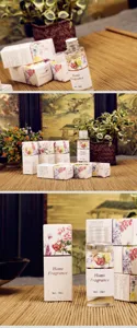 Details of 50ml home fragrance essential oil bottle with floral gift boxes on bamboo mat setup.