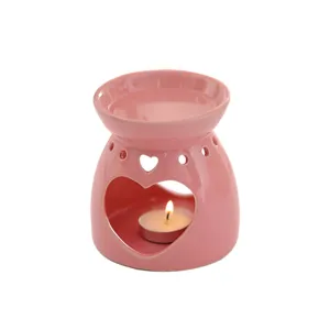 Rosa Keramik-Duftlampe mit Herzmotiv und brennender Teelichtkerze Geschenk