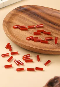 Detailed close-up showing texture of natural red agate cylindrical beads for jewelry DIY