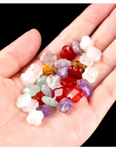High-detail close-up of mixed natural stone clover-shaped faceted beads held in hand.