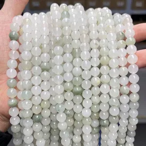 Detailed macro view of 6mm Xinjiang Tianshan Green jade round beads for DIY jewelry making