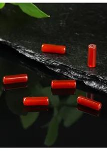High-quality macro view of polished natural red agate tube beads for DIY jewelry making.