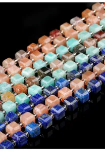 Macro detail of natural stone square sugar beads in multi-colored faceted cubes