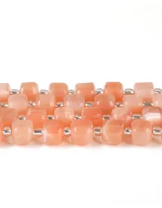 Macro detail shot of faceted peach natural stone cube beads for handmade jewelry making