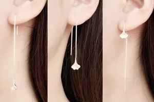 Detailed close-up showing three wearing styles of minimalist silver ginkgo leaf threader earrings