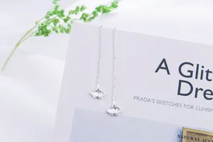 Close-up view showing the textured ginkgo leaf pendant and fine silver chain detail
