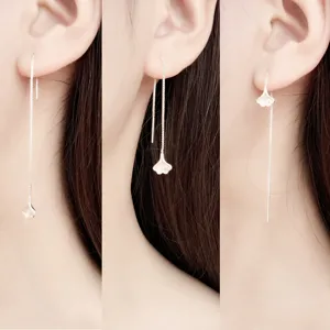 Minimalist silver gingko leaf long ear threads earrings for women on model