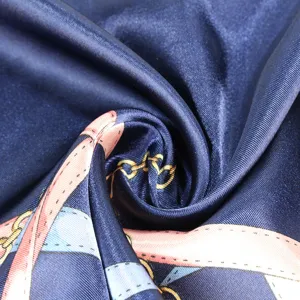 Vue macro détaillée d'un foulard en soie bleu marine avec chaînes dorées et motifs de ceinture