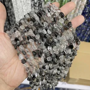 Close-up of 6-8mm natural black rutilated quartz irregular chip beads for jewelry DIY.
