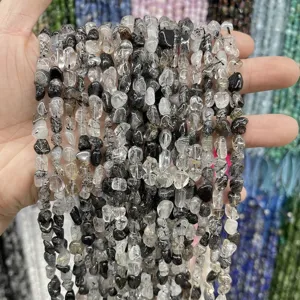 Macro view of 6-8mm natural irregular black rutilated quartz crystal beads for DIY jewelry