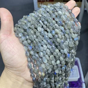 Macro view of natural labradorite irregular tumble beads showing vivid blue flash luster
