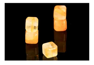 Detailed view of natural yellow quartz cube beads showing internal flower inclusions