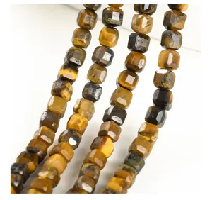 Macro view of natural yellow tiger eye faceted square beads for DIY jewelry making