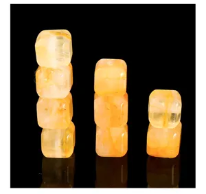 Detailed macro view of natural yellow phantom quartz cube beads for DIY jewelry crafts.