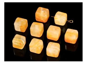 Close-up of square natural yellow glue flower crystal cube beads for jewelry making
