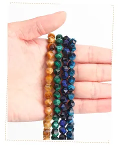 Close-up detail of faceted tiger eye rhombus beads in vibrant yellow, green, and blue colors.