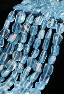 Gros plan de perles de pierres précieuses en aigue-marine naturelle bleu clair