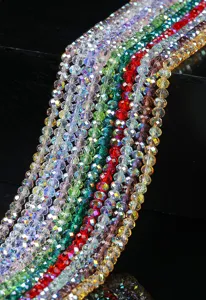 Close-up macro detail of vibrant faceted crystal glass beads with AB coating for DIY jewelry