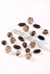 Primer plano de cuentas de cuarzo ahumado natural facetadas para creación de joyas DIY.