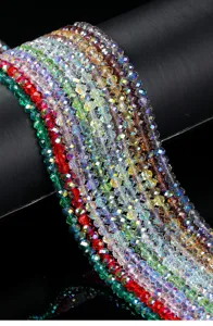 Close-up of colorful faceted crystal glass beads strands for DIY jewelry making.