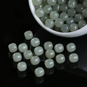 Macro detail of natural Hetian jade old-form barrel beads for DIY jewelry bracelet crafting