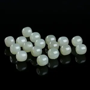 Detailed view of loose natural Hetian jade barrel beads for DIY bracelet jewelry making.