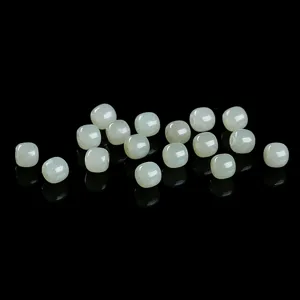 Detailed close-up view of natural Hetian jade loose barrel beads for DIY jewelry crafting.