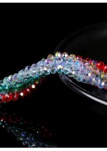 Close-up of faceted crystal glass rondelle beads in red, green, and iridescent AB finish