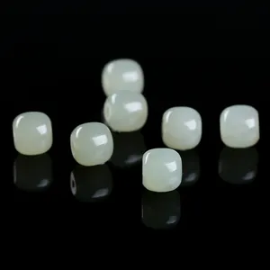 Macro detail showing smooth natural celadon jade barrel beads for diy jewelry making projects