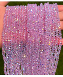 Close-up of sparkly pink faceted crystal glass beads with AB coating for DIY crafts
