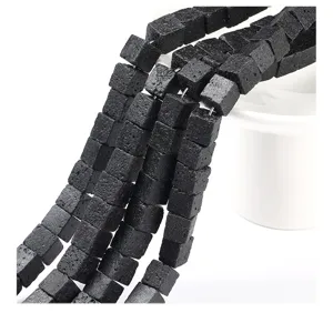 Close-up detail of natural black lava stone cube beads showing unique porous texture