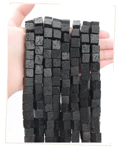 Close-up view of natural black porous lava stone cube beads for DIY jewelry making