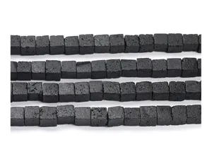 Close-up macro view of natural black porous lava stone cube loose beads for DIY jewelry