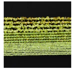 Macro detail of various natural peridot beads including chips and round shapes for DIY
