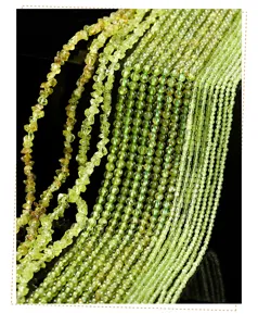 Close-up of natural peridot gemstone beads in various shapes for DIY jewelry making