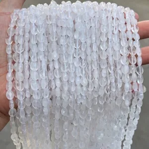 Close-up view of natural faceted white quartz oval beads for jewelry making.