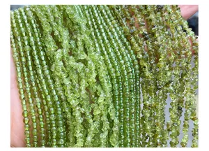 Close-up of natural green peridot chip and round beads for DIY jewelry making