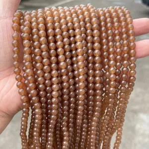 Handheld strands of natural brown chalcedony round beads for DIY jewelry making